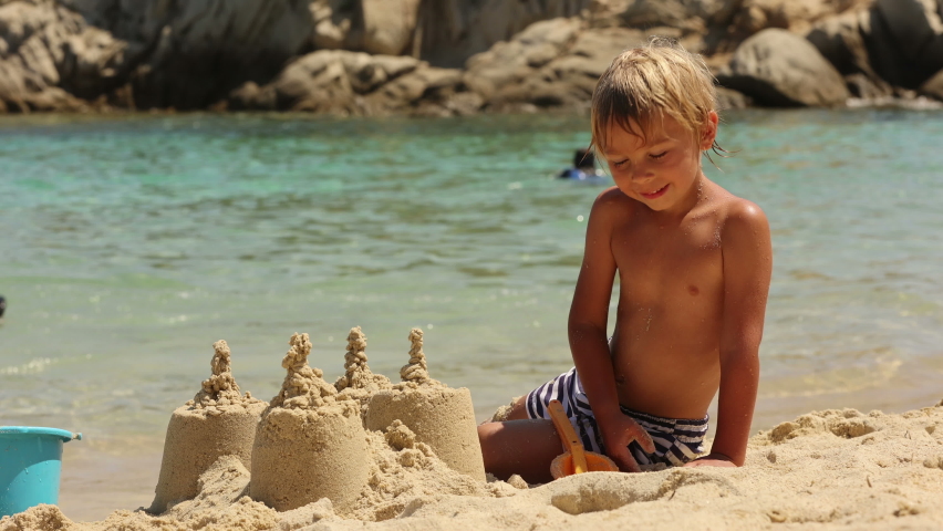 Happy child on the beach, enjoying summer, playing. Greece, Halkidiki