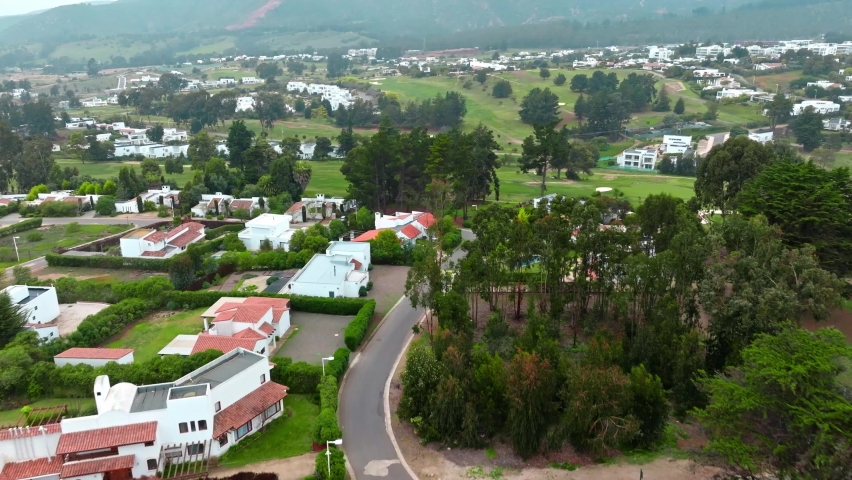 Aerial view push dolly in luxury homes private residential golf course