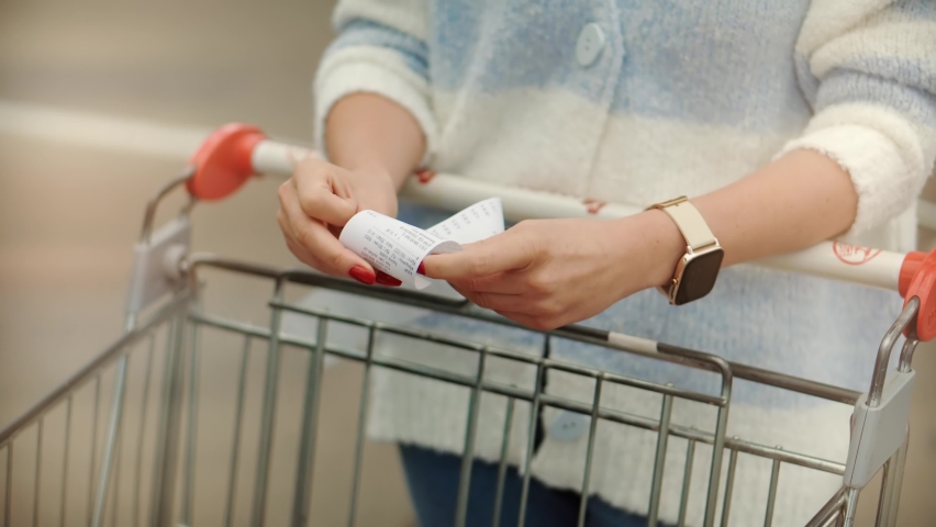 Home Finance Budget.Woman Check Bill Grocery Store Shopping Cart. Buyer Checks Paper Receipt On Shopping Supermarket. Customer Receipt Bill Expensive Total. Cash Register Money Spending On Hypermarket Royalty-Free Stock Footage #1093759099