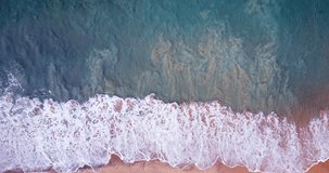 4K Nature video scene of Aerial view Top-down Beach sand and seawater wave in sunset time. Tropical Sea Andaman Sea : 4K Video High quality Apple ProRes HQ