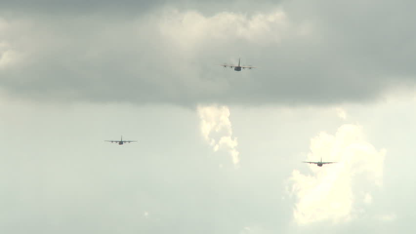 3 C130 transport planes flying at horizon