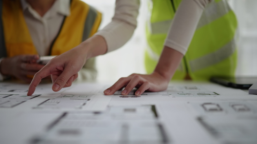 Closeup of hands engineer and architect team discussed about construction and architectural drawings works. Royalty-Free Stock Footage #1093763459