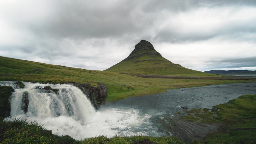 Timelapse of the clouds moving behing Kirkjufell in Iceland. The clouds move fast but the water moves in regulair speed. All insects, birds, cars etc. manually removed. 4k.