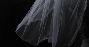 A white translucent veil blowing in the wind. Wedding veil on a dark background.  - Powered by Shutterstock - Get 15% off with code: PIKWIZARD15