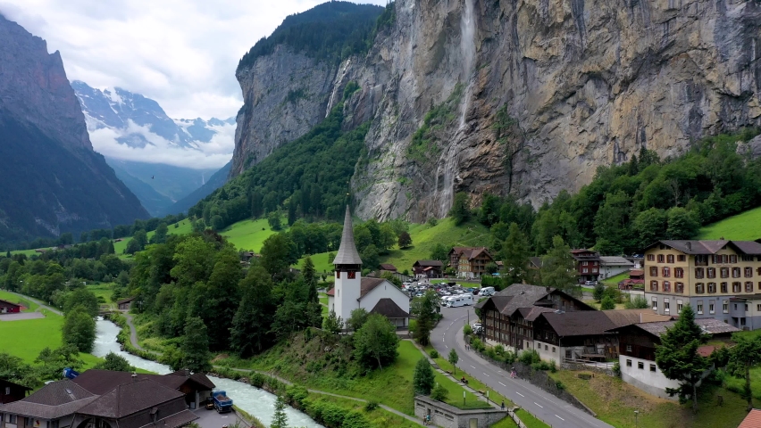 Famous Lauterbrunnen town and Staubbach waterfall, Bernese Oberland, Switzerland, Europe. Lauterbrunnen valley, Village of Lauterbrunnen, the Staubbach Fall, and the Lauterbrunnen Wall in Swiss Alps. Royalty-Free Stock Footage #1093771491