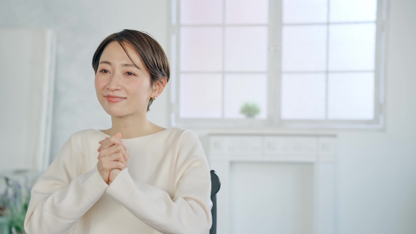 Asian middle-aged woman styling hair.