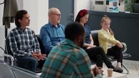 Different people waiting in row at hospital reception lobby to be called in office at checkup visit examination with specialist. Waiting room area for medical consultation at busy clinic. - Powered by Shutterstock - Get 15% off with code: PIKWIZARD15