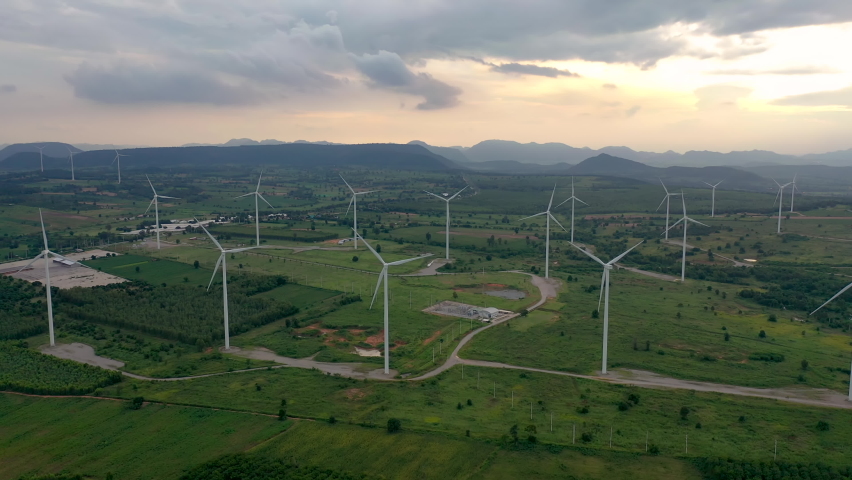 High angle view of wind turbine field from drone during beautiful morning sunrise. movement of spinning propellers. Alternative clean energy for sustainable  future | Shutterstock HD Video #1093775301
