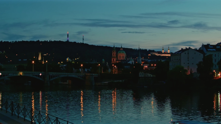 An amazing sunset in Prague. Prague city, light reflections in the water, 4K
