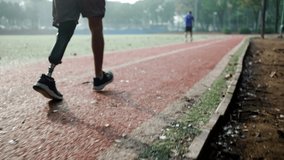 A middle aged disabled athlete with prosthetic leg running in slow motion. Determination concept - Powered by Shutterstock - Get 15% off with code: PIKWIZARD15