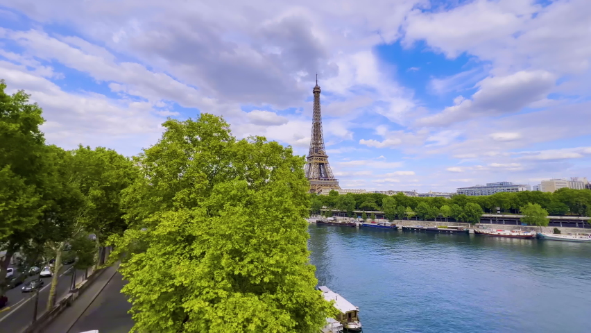  Aerial drone distant sunset view of Tour Eiffel Tower and Seine River bridge traffic cars driving, Paris city attractions, France  Royalty-Free Stock Footage #1093785341