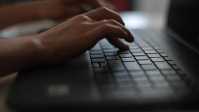 Close-up tracking shot of unrecognizable pupil boy typing on laptop keyboard, e-learning and online communication. Schoolchild using computer for education doing homework. Shooting in slow motion. - Powered by Shutterstock - Get 15% off with code: PIKWIZARD15