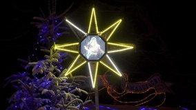 Christmas star shines above the nativity scene,a Christmas tree covered with snow and a star shining at night