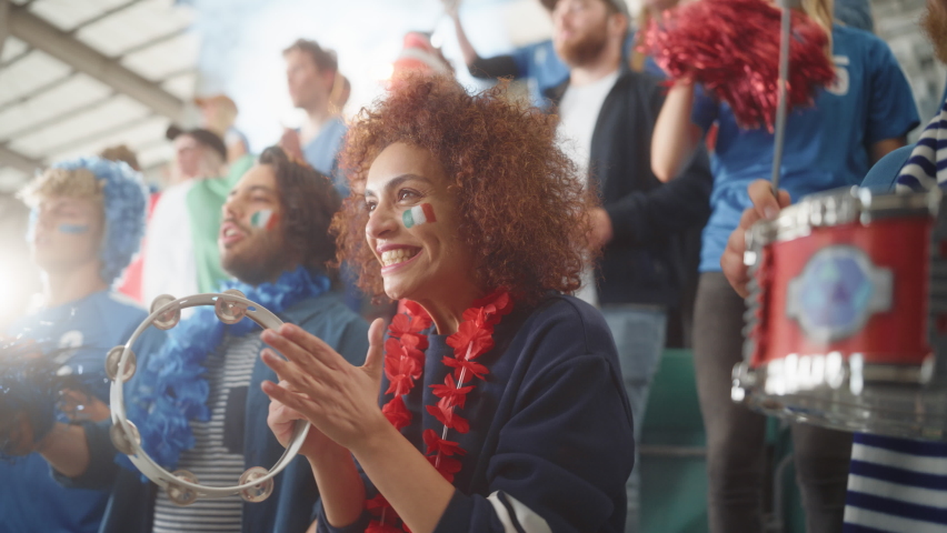 Sport Stadium Soccer Match: Portrait of Beautiful Bi Racial Fan Girl with Italian Flag Painted Face Cheering Team to Win, Beating Tambourine. Crowd Celebrate Goal, Championship Victory. Slow Motion Royalty-Free Stock Footage #1093794851