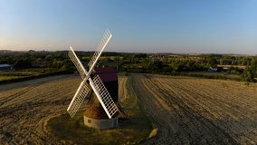 Video drone aerial view: old windmill. An old windmill in the countryside of England. Drone point of view famous windmill. 