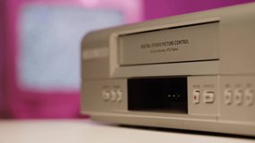 Old video recorder close-up, VHS. Retro player, video cassette broadcasting, audio tape. Watching vintage television. 