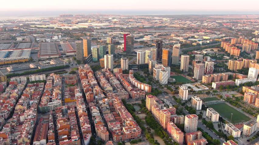 Barcelona city skyline at sunrise. Aerial view of business district of Gran Via and Plaça d'Europa with modern skyscrapers. Europa fira. Catalonia, Spain Royalty-Free Stock Footage #1093803953