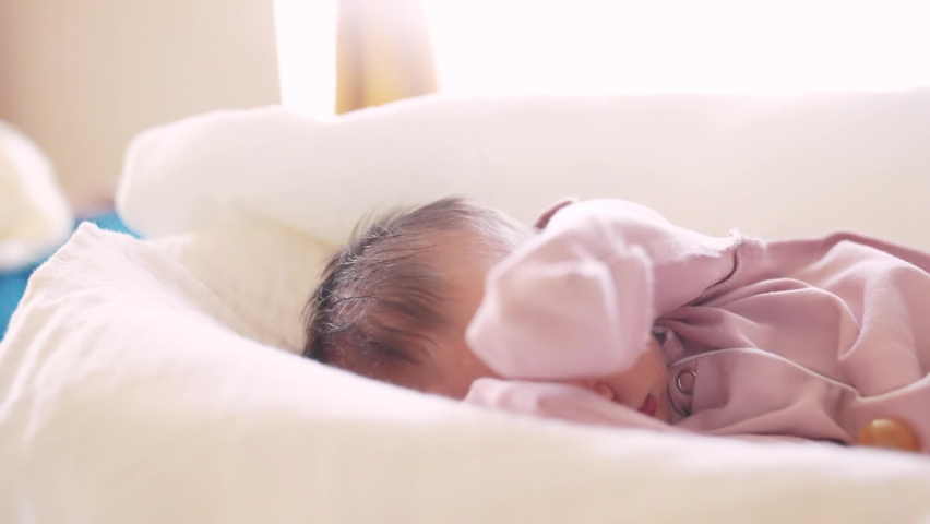 newborn baby sleeping. cute a brunette newborn baby sleeping in bed close up in maternity hospital lifestyle bedroom. happy family kid dream concept. cute newborn baby girl sleeping close up Royalty-Free Stock Footage #1093806655