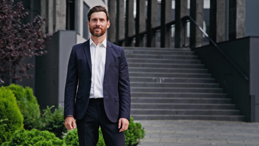 Excited happy businessman standing outdoors rejoicing in victory young male manager entrepreneur celebrating business success promotion professional achievement getting promoted making yes gesture Royalty-Free Stock Footage #1093813779