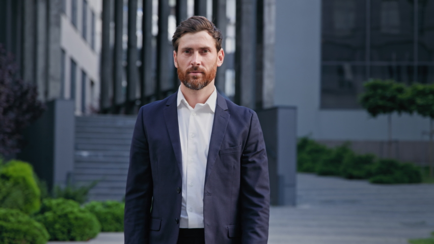 Successful confident businessman in stylish suit standing on background office building smiling looking at camera handsome caucasian male leader professional worker posing with crossed arms outdoors Royalty-Free Stock Footage #1093813787