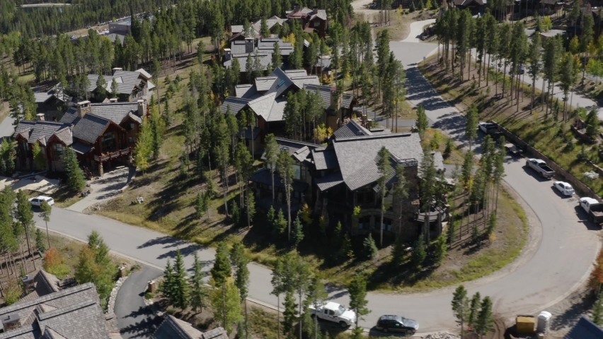Aerial view away from holiday cabins in Breckenridge, Colorado - rotating, pull back, drone shot