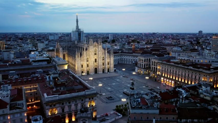 Aerial view of the statue of the Madonna on the central spire of the duomo and the city's cathedral at dawn. Roofs of houses and skyscrapers. Sun over the horizon. duomo square. Italy, Milan, 08.2022 | Shutterstock HD Video #1093825983