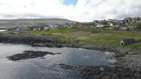Faroe Islands shoreline town panorama filmed by drone