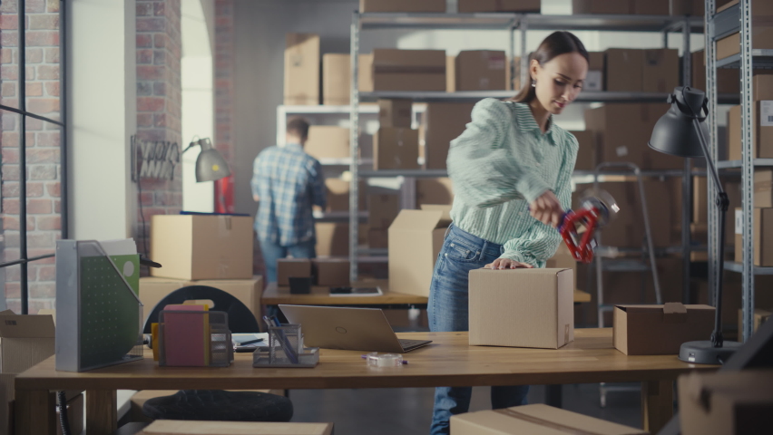 Beautiful Storeroom Worker Preparing a Small Parcel for Postage. Inventory Manager Taping a Cardboard Box Before Shipping It to Customer. Small Business Owner Working in Warehouse Facility.