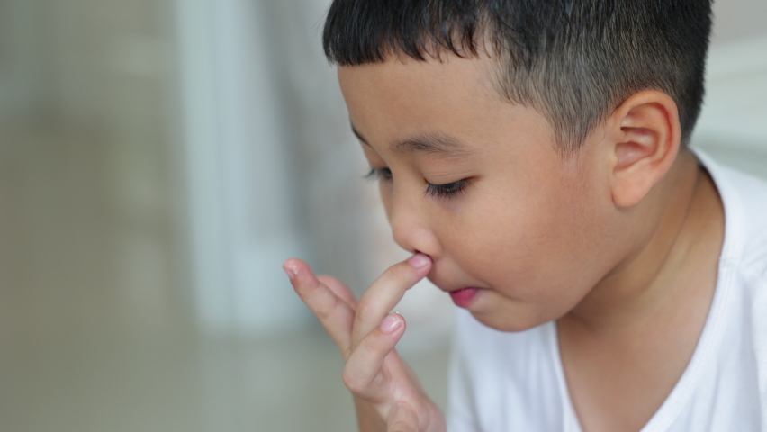 Asian allergy kid used his finger wipe  snot from his nose. Royalty-Free Stock Footage #1093831091