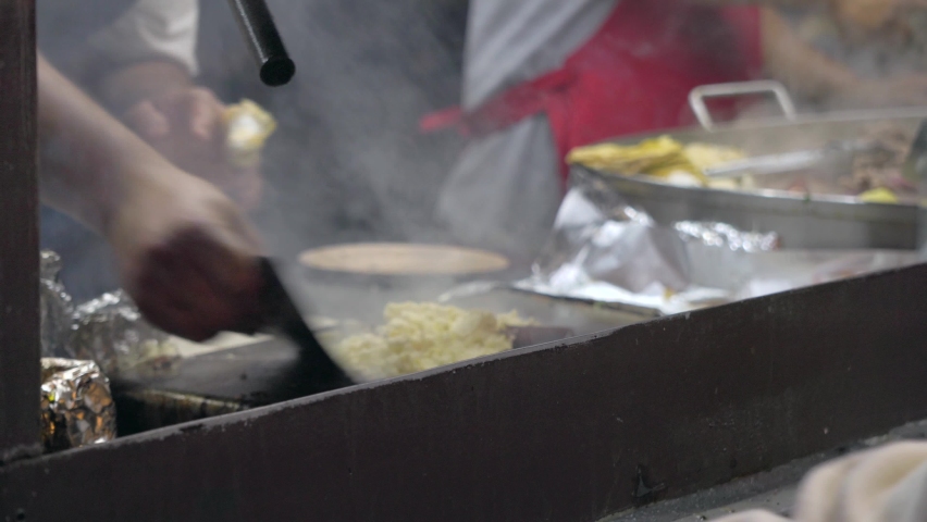 Open air Mexican taqueria Street food Restaurant Where two Mexicans are making tacos and quesadillas Royalty-Free Stock Footage #1093845173