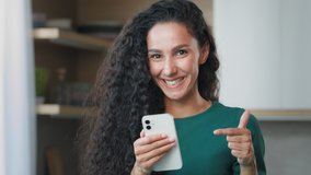 Surprised woman female winner housewife lucky arab hispanic girl with curly hair win game on mobile phone shopping online rejoice discounts in internet store delighted user point finger on - Powered by Shutterstock - Get 15% off with code: PIKWIZARD15