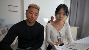 POV of young Asian man and Asian brunette woman working at new project in office. Colleagues develop plan of work at online video conference closeup