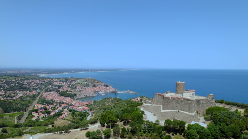 Aerial shot of the fort standing on top of the mountain in Collioure, Occitania. (France) Royalty-Free Stock Footage #1093855601