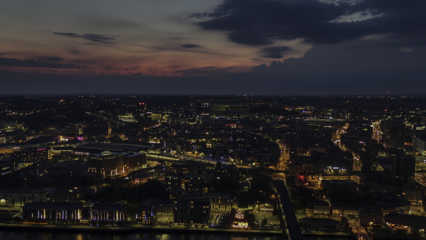 Establishing Aerial View Shot of Newcastle upon Tyne UK, Tyne and Wear, England United Kingdom night evening sunset, slow tracking right, whole city panorama