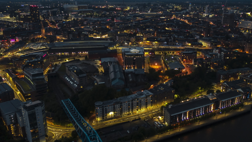 Establishing Aerial View Shot of Newcastle upon Tyne UK, Tyne and Wear, England United Kingdom looking down at night evening, cinematic light