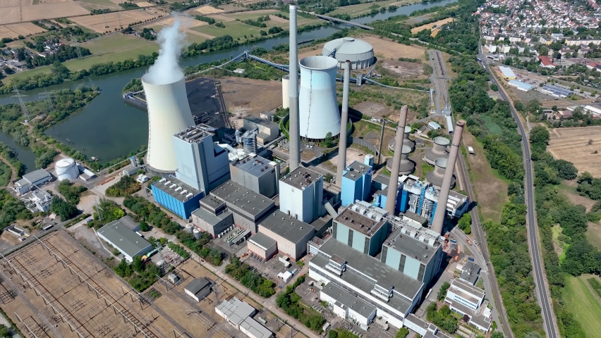 Aerial view of chimneys of power plant, an industrial district. Modern large thermal power plant in Germany, Europa. Generation through coal switched over to natural gas Royalty-Free Stock Footage #1093864599