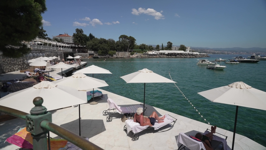 Boats and sun loungers on the Lungomare promenade in the town of Opatija, Opatija, Eastern Istria, Croatia, Europe
