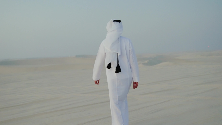 men with qatari traditional outfit walking in the desert of Qatar
 Royalty-Free Stock Footage #1093866281