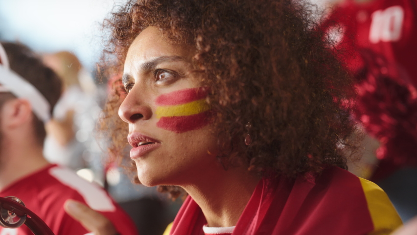 Sport Stadium Soccer Match: Portrait of Beautiful Bi Racial Fan Girl with Spanish Flag Painted Face Cheering Team to Win, Beating Tambourine. Crowd Celebrate Goal, Championship Victory. Slow Motion Royalty-Free Stock Footage #1093867141