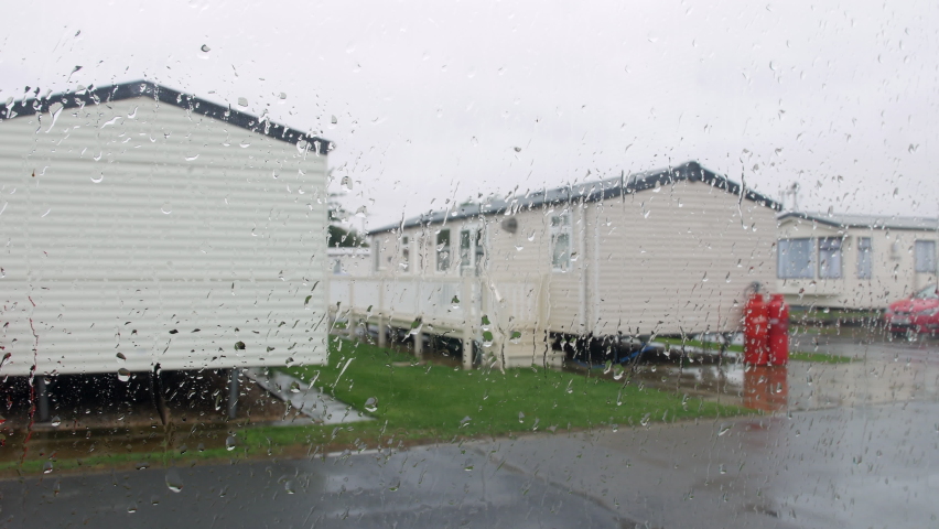 Rain falling on a caravan trailer vacation camp on a wet raining staycation at a British holiday seaside resort