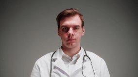 Doctor portrait, nurse, therapist. Medical worker posing on grey background in studio. Man wearing stethoscope, surgical uniform, looking in camera. Healthcare and medicine. - Powered by Shutterstock - Get 15% off with code: PIKWIZARD15