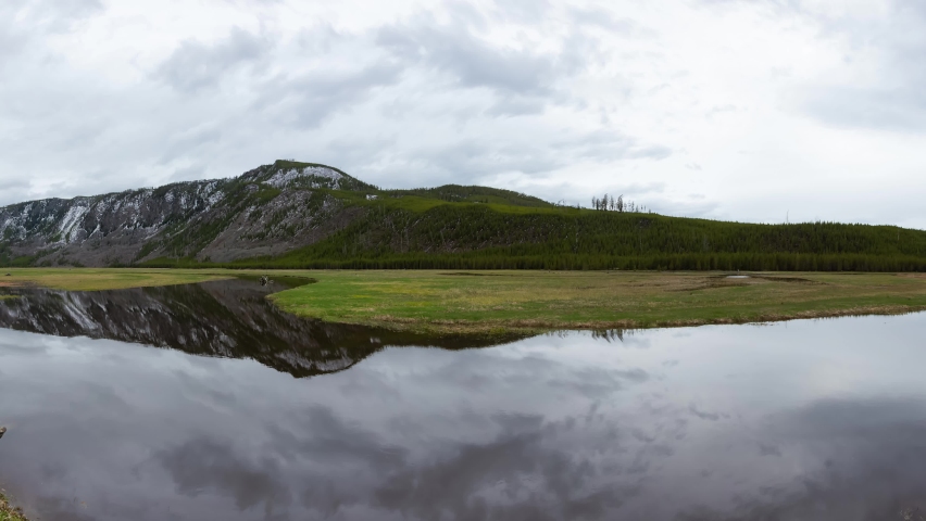 Cinemagraph Continuous Loop. Madison River in American Mountain Landscape. Cloudy Spring Season Day. Yellowstone National Park, Wyoming, United States. Nature Background