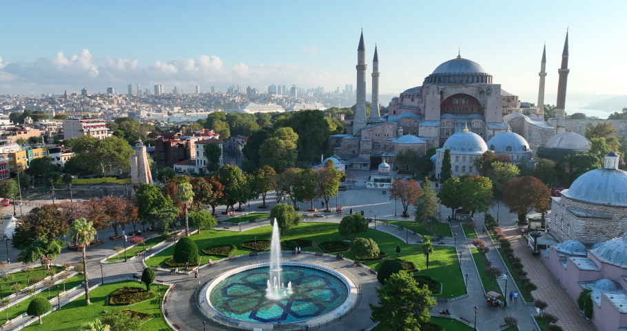 Istanbul, Turkey. Sultanahmet with the Blue Mosque and the Hagia Sophia with a Golden Horn on the background at sunrise. Cinematic Aerial view.