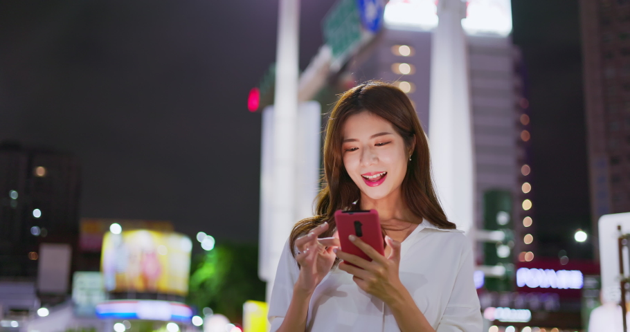 asian businesswoman use 5g smart phone outdoor on city street in the evening Royalty-Free Stock Footage #1093888885