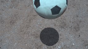 soccer ball bouncing on the dirt field