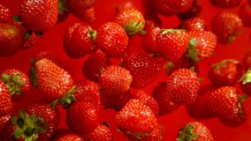 Super Slow Motion Shot of Fresh Strawberries on Red Background Flying Towards Camera at 1000fps. - Powered by Shutterstock - Get 15% off with code: PIKWIZARD15