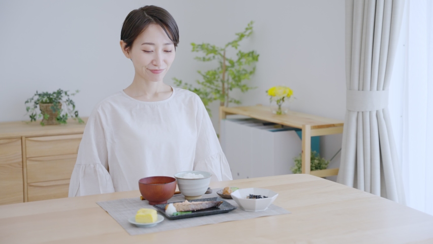 Asian woman eating a meal Royalty-Free Stock Footage #1093894571