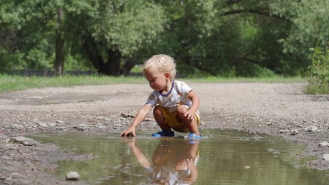 Happy Child Having Fun Playing Puddle Stock Footage Video (100% Royalty ...
