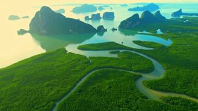 Drone flying over tropical forest, beautiful mangroves and winding river in sunrise time. (Samed Nang Chee), Phang Nga, Thailand. green nature background. tropical seas in southeast asia. 4k drone
