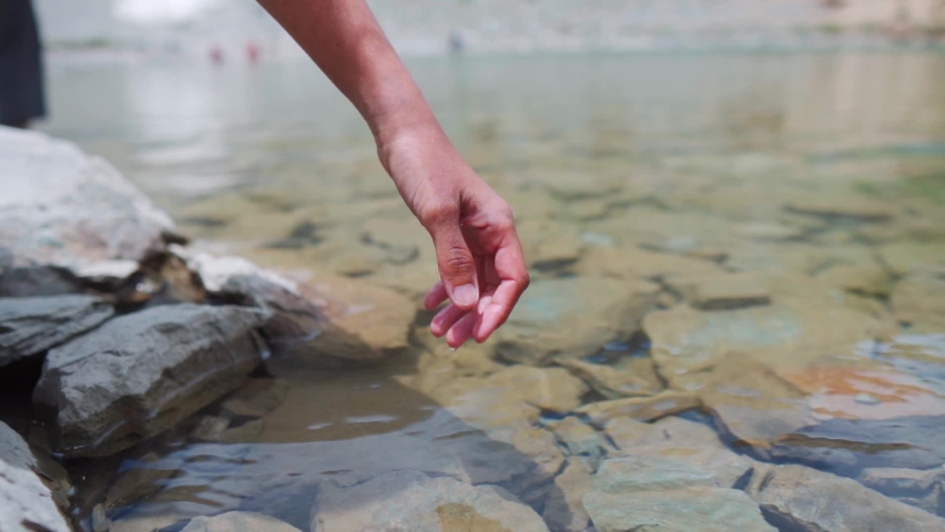 Female hand touching water in the calm Himalayan Lake during summer time. At Deepak Tal, Himachal Pradesh. Traveler enjoying feel the nature. Life concept. Slow motion shot. | Shutterstock HD Video #1093898455
